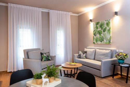 a living room with a couch and a table at Erettz Dafna Travel Hotel in Metsudat Menahem Ussishkin Alef