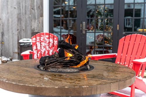 a wooden table with a fire in the middle at The Barnstead Inn in Manchester Center