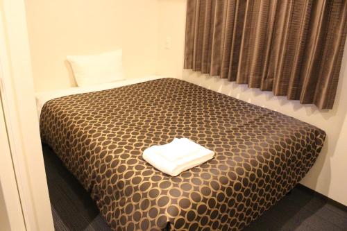 Tempat tidur dalam kamar di Hotel Excellence Kyoto Station Hachijo
