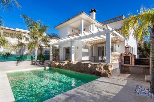 a house with a swimming pool in front of it at Villa Sol Felostal in Palma de Mallorca