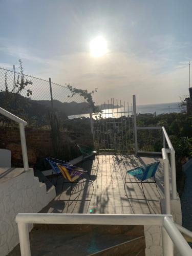 two chairs on a patio with a view of the ocean at Vito Hotel Boutique Taganga in Taganga
