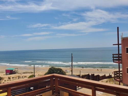 a view of the beach from a balcony at Lobos de Mar in Punta Del Diablo