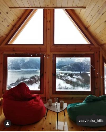 a room with a large window in a wooden cabin at Zaovinska idila in Bjeluša