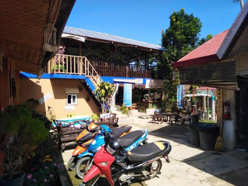 a group of motorcycles parked in front of a building at Mama Hostel & Guest House in El Nido