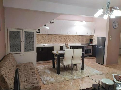 a kitchen with a table and chairs in a room at Luxurious private appartment with garden and view! in Serres