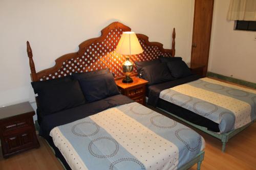 a living room with two beds and a couch at Home Sweet Home in Cuernavaca