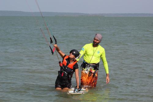a man and a woman are standing in the water at Margarita Village kite school kalpitiya in Kalpitiya