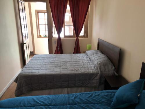 een slaapkamer met 2 bedden en een raam bij Hostal Ansaldi in Valparaíso