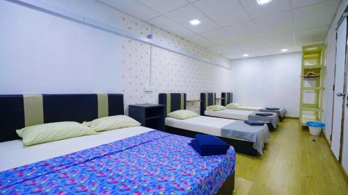 a room with three beds and a ladder at Pak Long Shoplot Homestay in Shah Alam