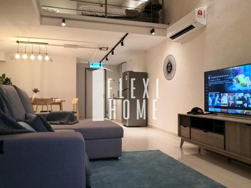 a living room with a large tv and a couch at NETFLIX-Pinnacle PJ, Fantastic City View, 1-6 Guests Designed Duplex Home by Flexihome-MY in Petaling Jaya