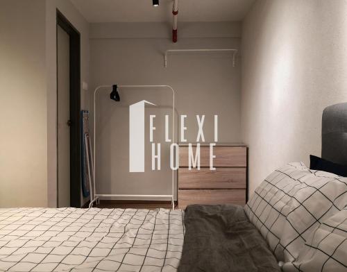 a bedroom with a bed and a sign that reads flex i home at NETFLIX-Pinnacle PJ, Fantastic City View, 1-6 Guests Designed Duplex Home by Flexihome-MY in Petaling Jaya