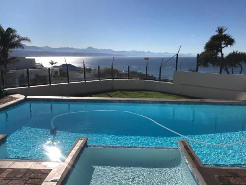 a swimming pool with a view of the ocean at Seaviews from Arrowood in Plettenberg Bay