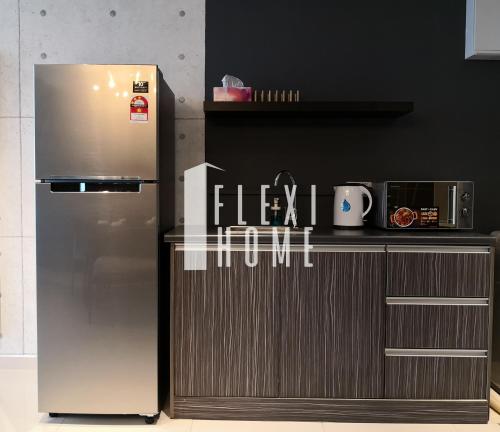 a stainless steel refrigerator in a kitchen next to a counter at NETFLIX-Pinnacle PJ, Fantastic City View, 1-6 Guests Designed Duplex Home by Flexihome-MY in Petaling Jaya