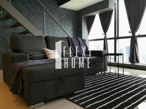 a living room with a couch and a large window at NETFLIX-Pinnacle PJ, Fantastic City View, 1-6 Guests Designed Duplex Home by Flexihome-MY in Petaling Jaya