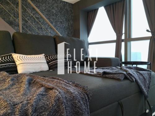 a couch with a blanket on it in a room with windows at NETFLIX-Pinnacle PJ, Fantastic City View, 1-6 Guests Designed Duplex Home by Flexihome-MY in Petaling Jaya