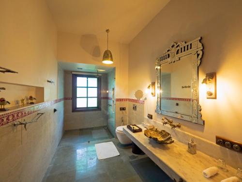bagno con lavandino e specchio di Tree of Life Resort & Spa Varanasi a Varanasi