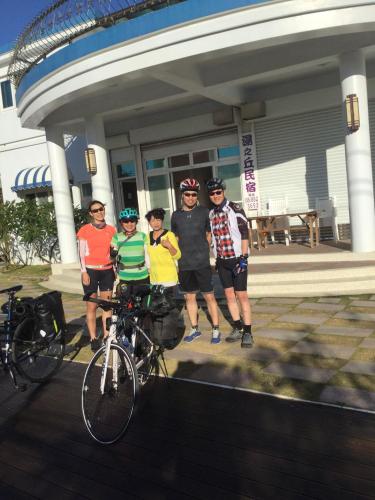 a group of people standing in front of a building with their bikes at Hot Spring Hill B&B in Checheng