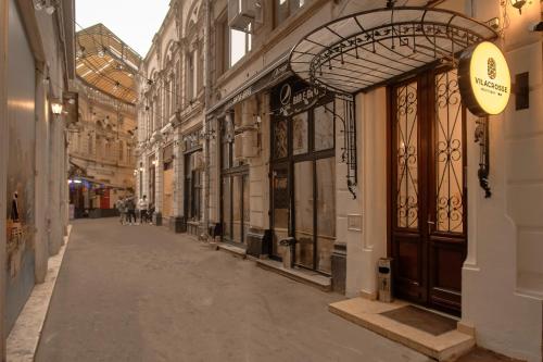 an empty street in a city with a building at Vilacrosse Boutique Inn in Bucharest