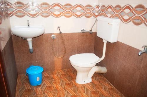 a bathroom with a toilet and a sink at Heather Home Stay in Cochin