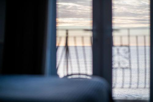 a view of a beach through a window at The Elizabeth in Sidmouth