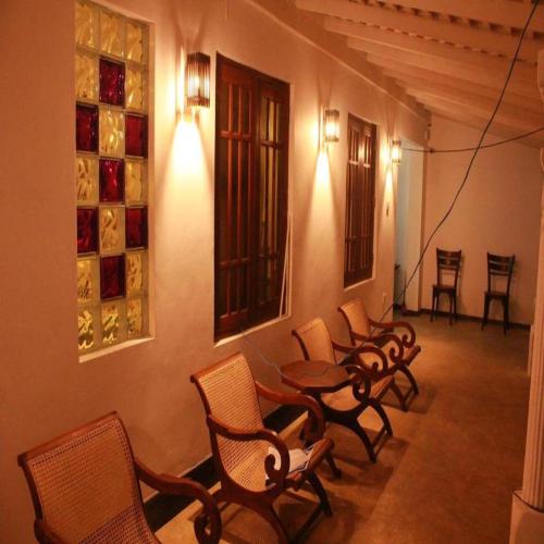 a group of chairs and tables in a room at Villa Koggala in Koggala