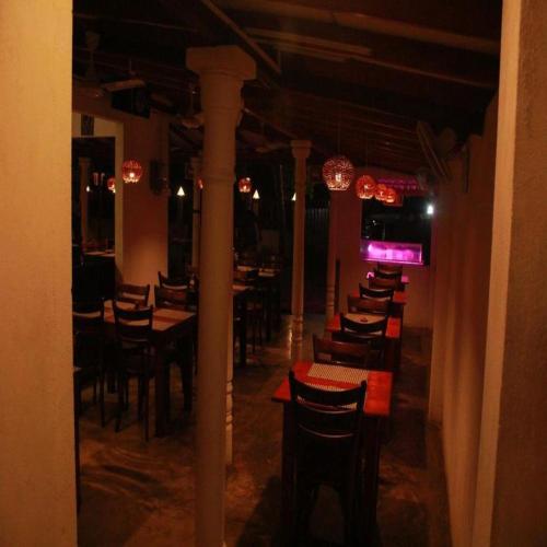 a room with tables and chairs in a restaurant at Villa Koggala in Koggala