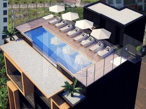 an overhead view of a swimming pool with lounge chairs and a swimming pool at Madeira Mar - "Seaside" in Funchal