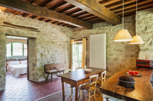 a dining room with a table and a bedroom at Resort con vista nel Chianti Rufina in Londa