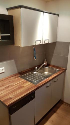 a kitchen with a sink and a counter top at 3 Sterne Ferienwohnung Pape in Schmallenberg