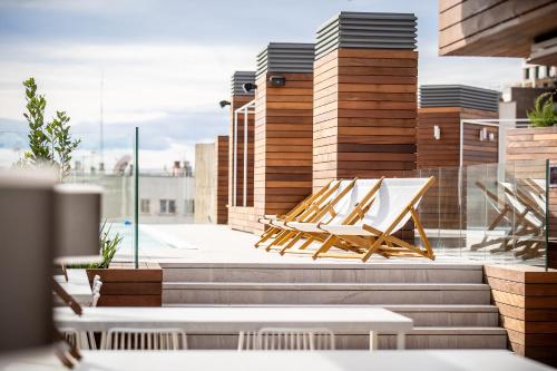 a group of chairs sitting on the side of a building at INNSiDE by Meliá Zaragoza in Zaragoza