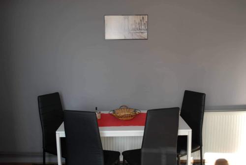 a table with a flag on it with four chairs at Stan na dan - apartman Djordjevic in Vranje