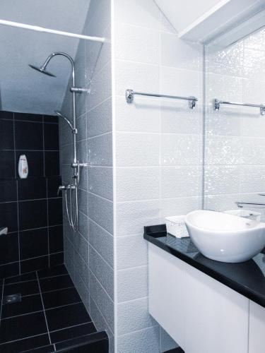 a bathroom with a sink and a glass shower at Stan na dan - apartman Djordjevic in Vranje