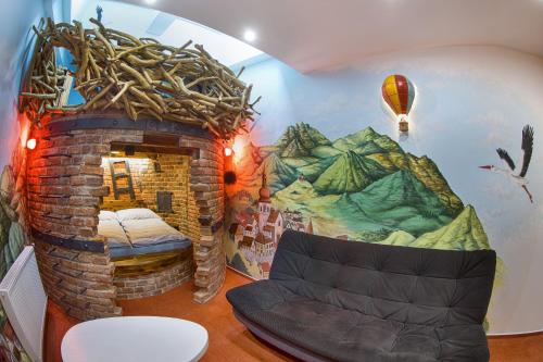a room with a fireplace and a room with a bed in it at Hotel Kocourkov in Hlinsko