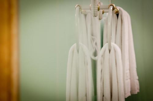 a group of white towels hanging on a rack at Deja Vu Hotel in Taipei
