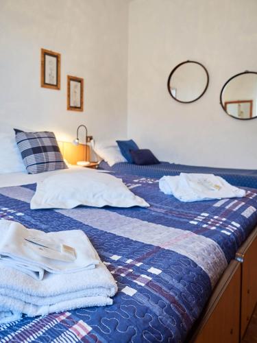 a bedroom with two beds with towels on them at Appartamento Ghisallo in Magreglio