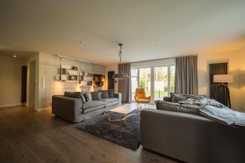 a large living room with two couches and a couch at KajüteSieben in Sankt Peter-Ording