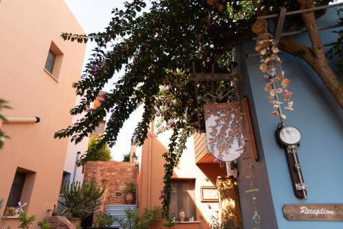 a clock on the side of a building at AnnaDes Apartments & Studios Chios in Karfas