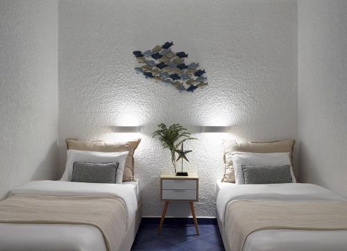 two beds sitting next to each other in a room at Nikis Village in Poros
