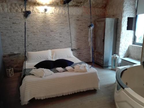 a bedroom with a large bed with towels on it at Only for two Giumbabulla in Ragusa