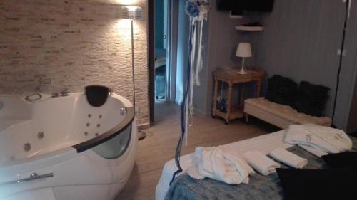 a bathroom with a bath tub and a sink at Only for two Giumbabulla in Ragusa