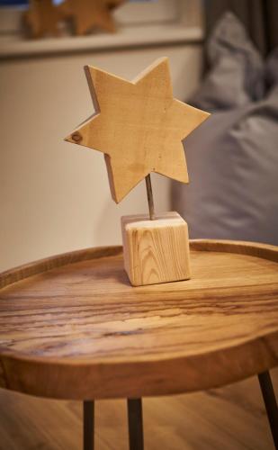 a wooden star on top of a wooden table at Appartements Der Fuchsbau in Saalbach Hinterglemm