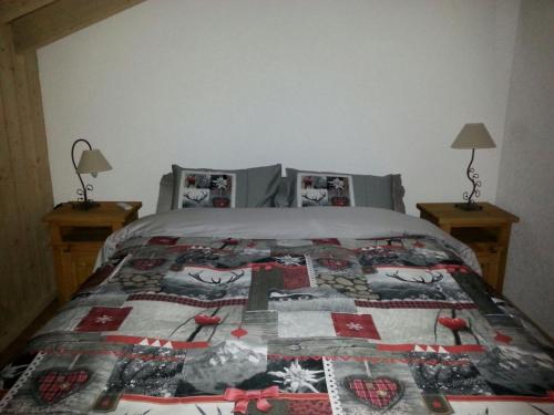 a bedroom with a bed with a quilt on it at Les Combles des Murailles in Champéry