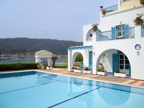 a large swimming pool in front of a building at Nikis Village in Poros