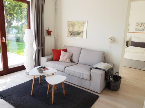 a living room with a couch and a table at Ferienwohnungen am Danewerk in Dannewerk