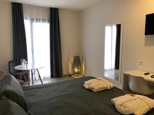 a bedroom with a bed with two towels on it at Hotel Gran Sol De Extremadura in Montijo