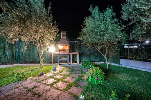 a garden at night with a lantern on a table at Arcobaleno Apartment in Fondi