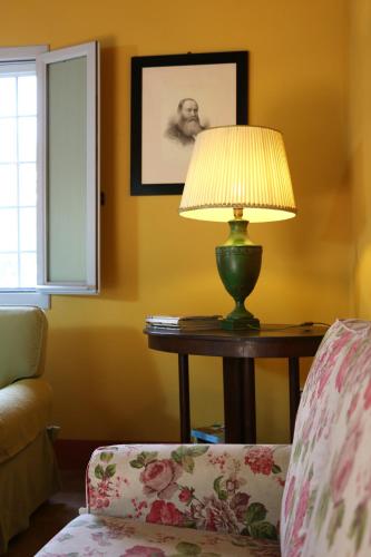 a lamp sitting on a table next to a chair at BORGO GIUSTINIANI Mora Pero Melo in San Martino di Venezze