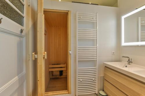 a bathroom with a sink and a toilet and a mirror at Church conversion for a unique stay and experience in Rinsumageest