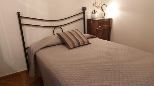 a bed with a pillow on it in a bedroom at La Limonaia Country House in Monteriggioni