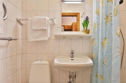 
a bathroom with a sink, toilet, and bathtub at Pesa Hotel in Põlva
